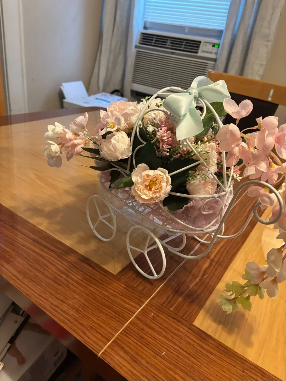 White Metal Baby Carriage Floral Centerpiece with Pink Silk Flowers.